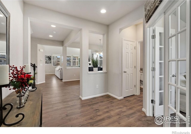 entrance foyer featuring dark hardwood / wood-style flooring and a chandelier