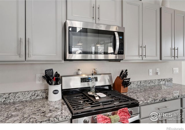 kitchen featuring light stone countertops and stainless steel appliances