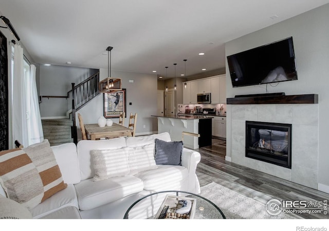 living room with hardwood / wood-style floors and a fireplace