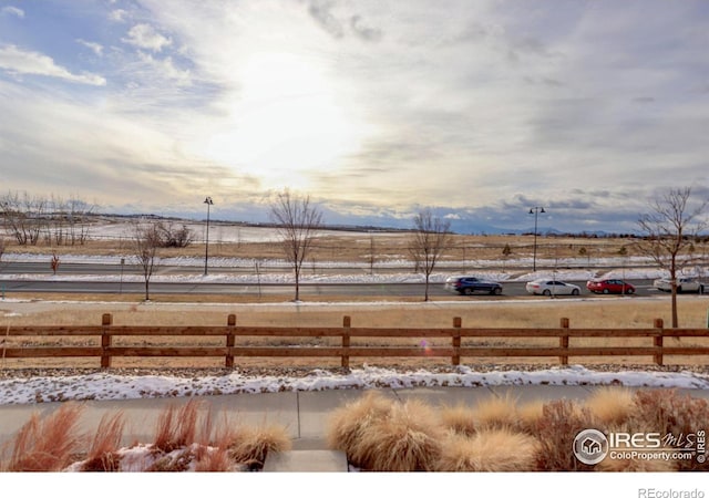 snowy yard featuring a rural view