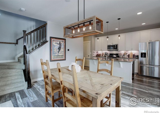 dining area featuring dark hardwood / wood-style flooring and sink