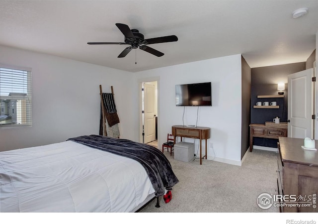 bedroom with ceiling fan and light carpet