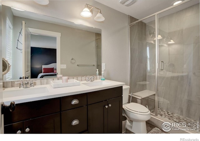 bathroom featuring vanity, an enclosed shower, and toilet