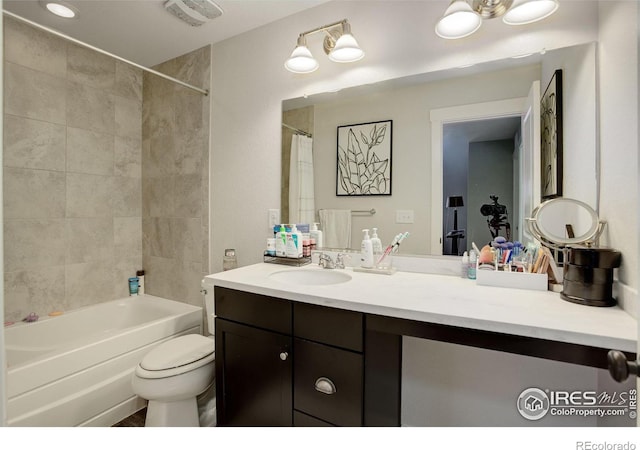 full bathroom with shower / bath combination with curtain, vanity, and toilet