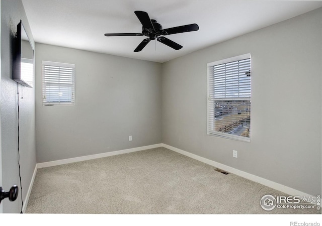 empty room with carpet flooring and ceiling fan