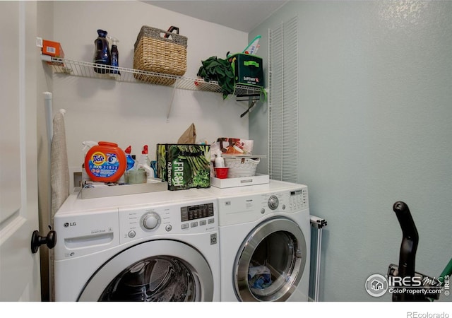 washroom with washing machine and clothes dryer