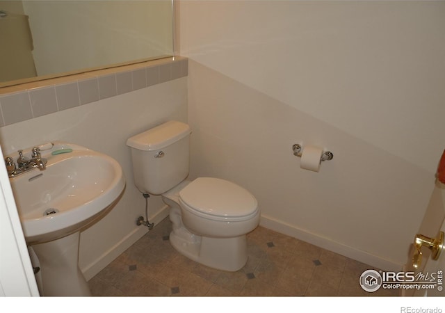 bathroom featuring tile patterned floors, toilet, and sink