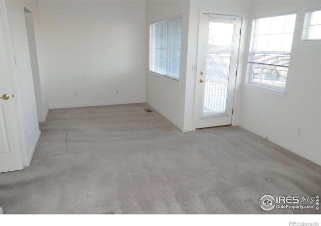 doorway with light colored carpet