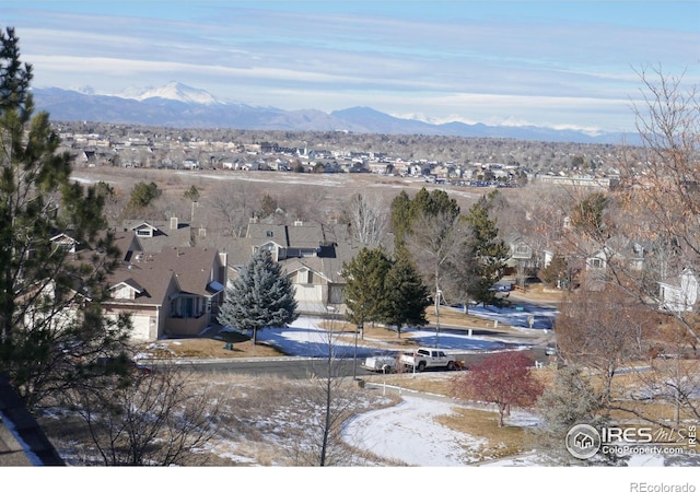 snowy aerial view with a mountain view