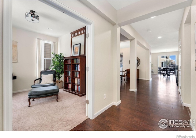 hall featuring dark wood-style floors, baseboards, and recessed lighting