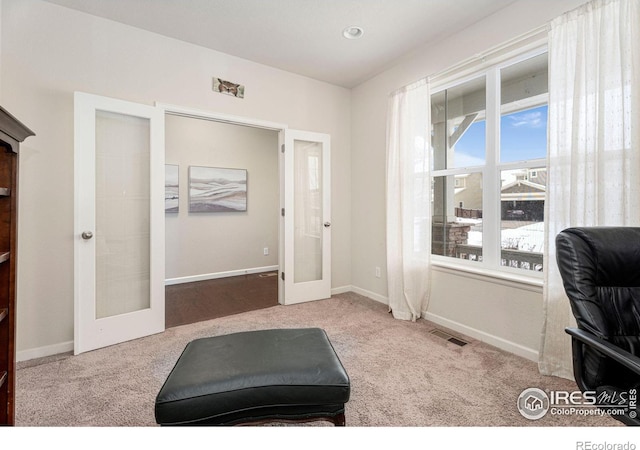 carpeted office space with french doors, visible vents, and baseboards