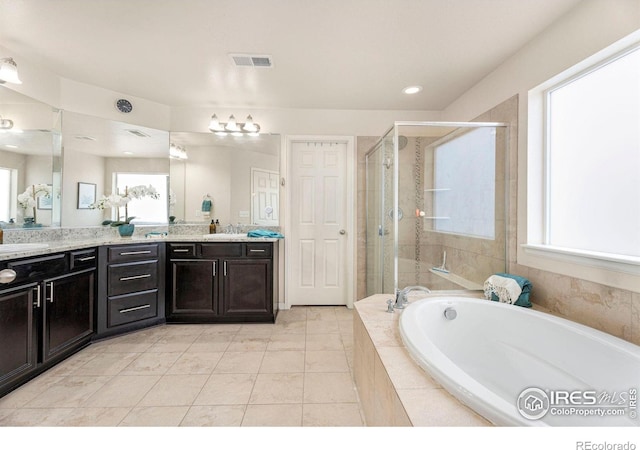 bathroom featuring a garden tub, visible vents, a stall shower, vanity, and tile patterned floors