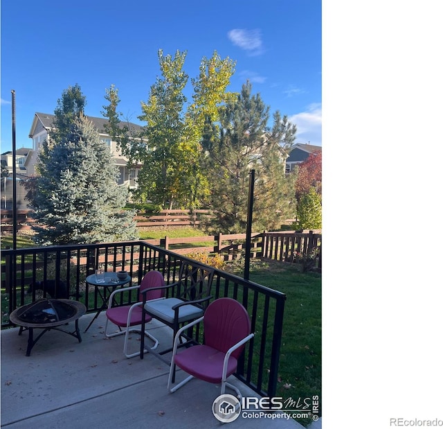 wooden deck with fence and a fire pit