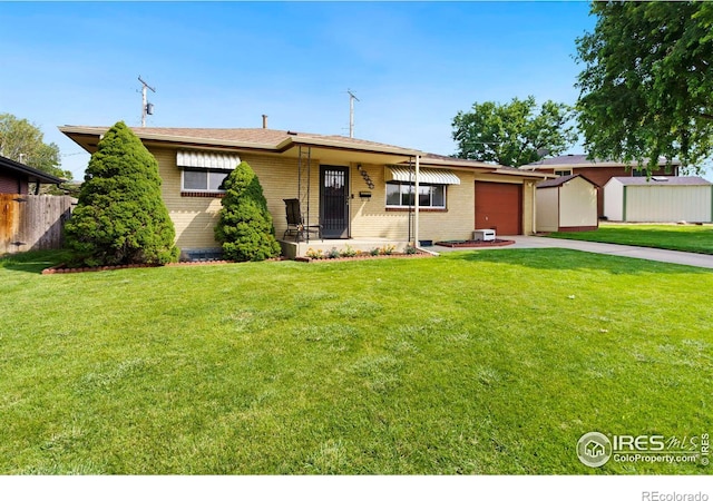 single story home featuring a storage unit, a porch, a front lawn, and a garage