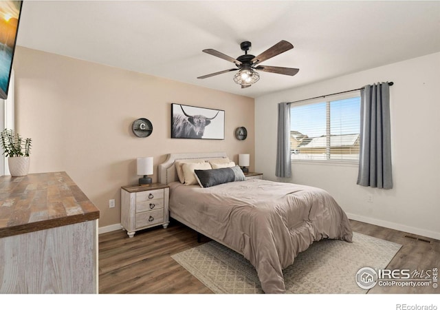 bedroom featuring ceiling fan and dark hardwood / wood-style floors