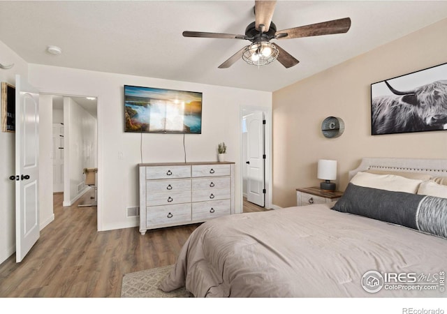 bedroom with dark wood-type flooring and ceiling fan