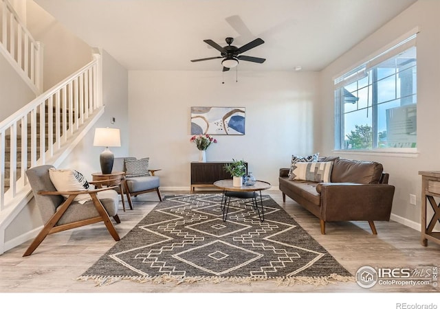 living room with hardwood / wood-style flooring and ceiling fan