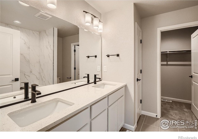 bathroom featuring tile patterned floors, vanity, and toilet