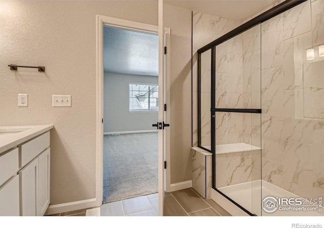 bathroom with a shower with door and a textured ceiling