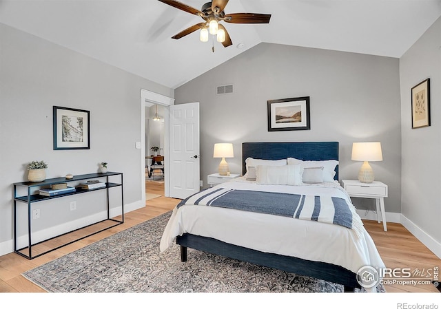 bedroom with ceiling fan, hardwood / wood-style floors, and lofted ceiling