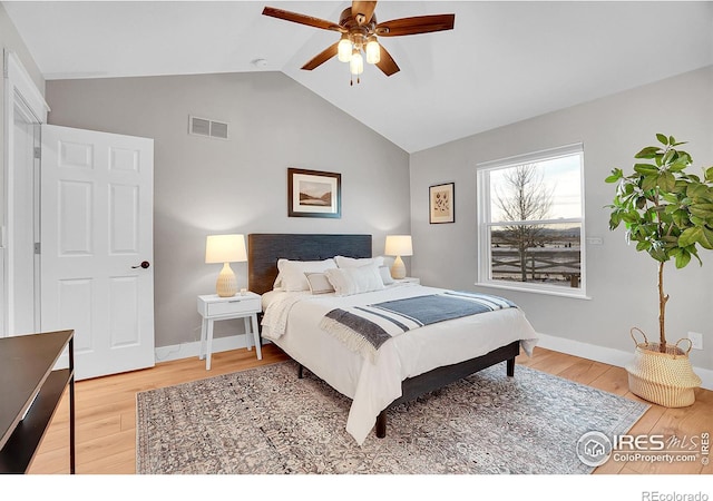 bedroom with ceiling fan, wood-type flooring, and lofted ceiling