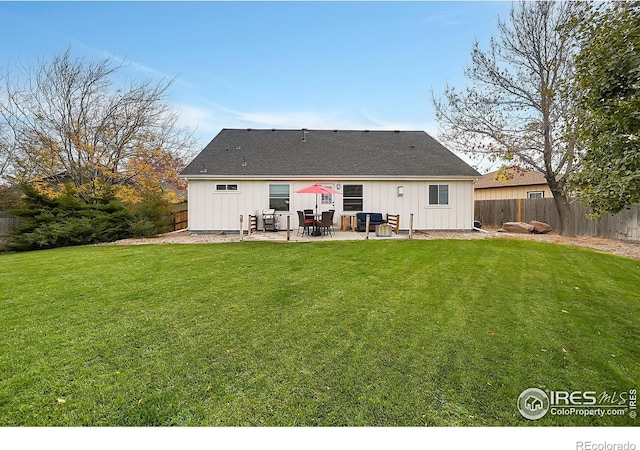 rear view of property with a lawn and a patio area