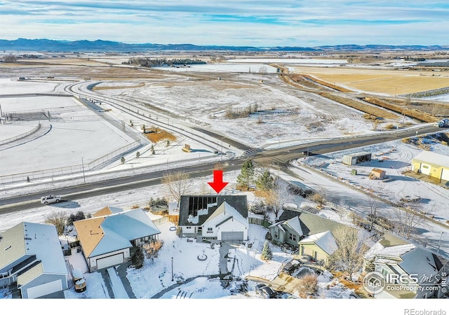 snowy aerial view featuring a mountain view