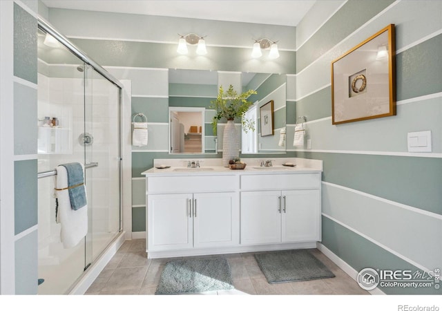 bathroom featuring tile patterned flooring, vanity, and a shower with door