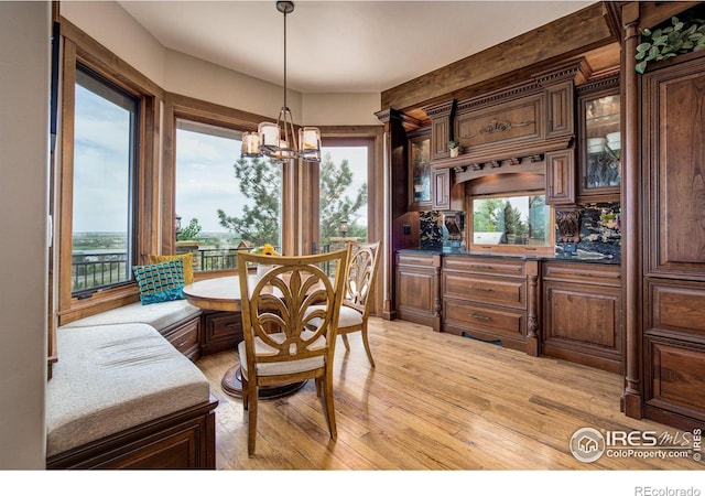 dining area featuring a chandelier, breakfast area, and light hardwood / wood-style flooring