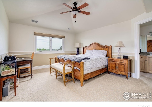 bedroom with connected bathroom, ceiling fan, light colored carpet, and vaulted ceiling