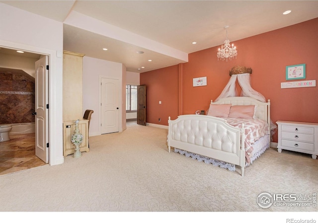 carpeted bedroom with an inviting chandelier and ensuite bath