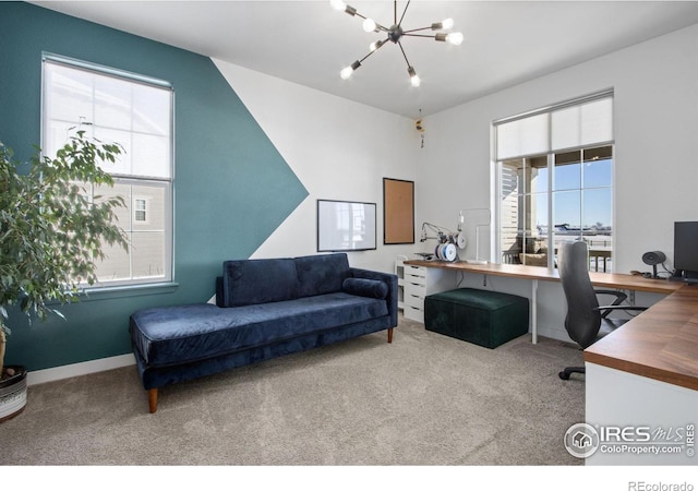 home office with carpet floors and a notable chandelier