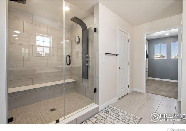 bathroom featuring tile patterned flooring and an enclosed shower