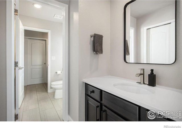 bathroom featuring vanity and toilet