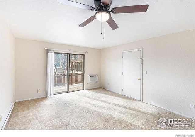 carpeted empty room featuring a wall unit AC and ceiling fan