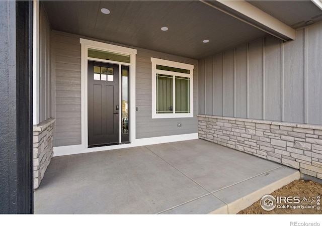 view of exterior entry with a porch