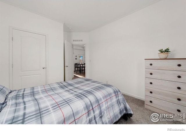 bedroom with carpet floors, baseboards, and visible vents