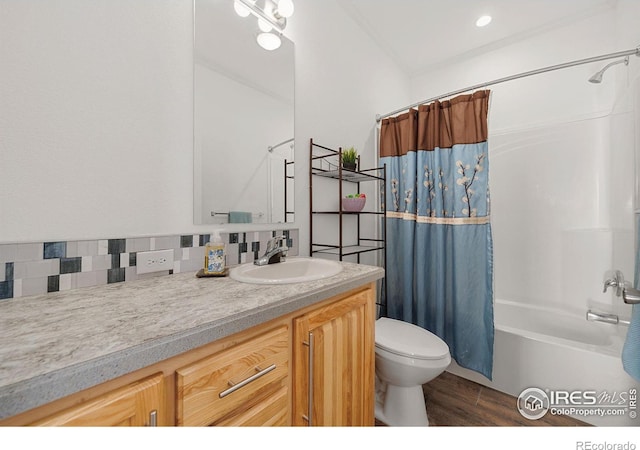 full bath with tasteful backsplash, toilet, wood finished floors, shower / bath combination with curtain, and vanity