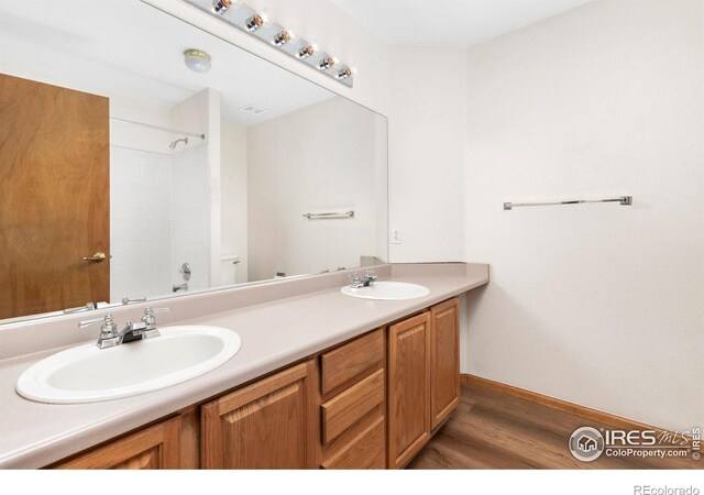 bathroom with hardwood / wood-style floors and vanity