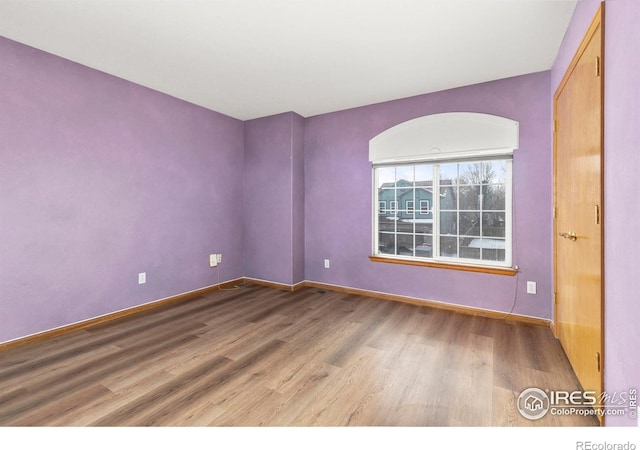 unfurnished room featuring hardwood / wood-style floors