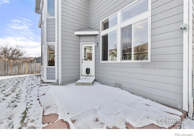 view of snow covered property entrance