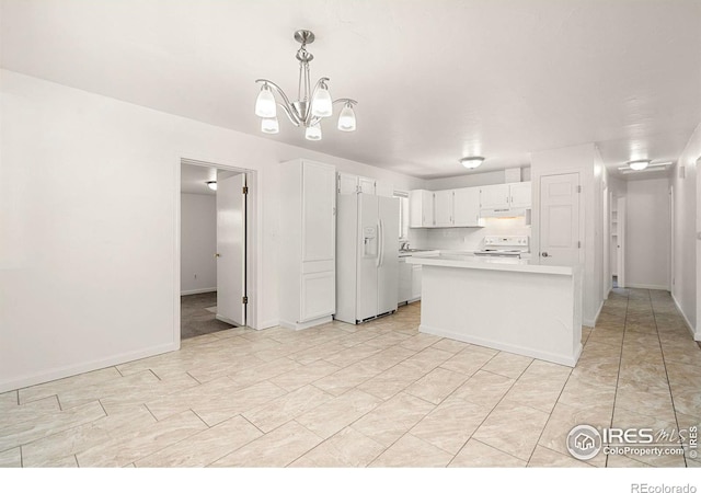 kitchen with an inviting chandelier, white cabinets, white fridge with ice dispenser, decorative light fixtures, and range