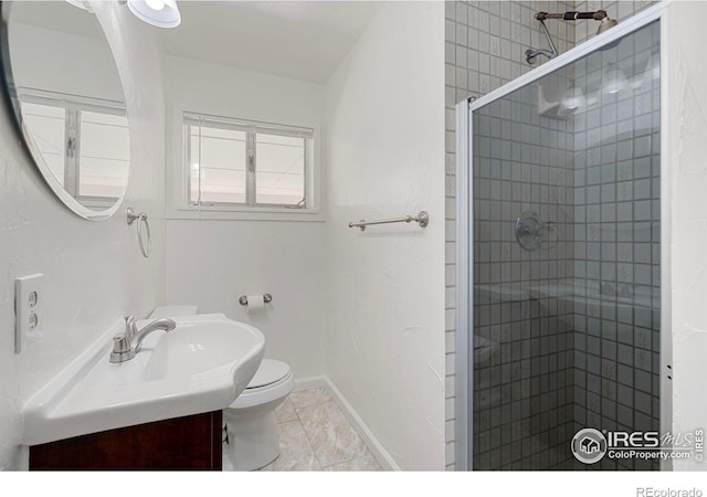 bathroom with tile patterned flooring, vanity, toilet, and a shower with door