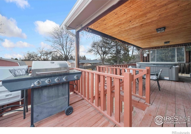 deck featuring grilling area and a hot tub