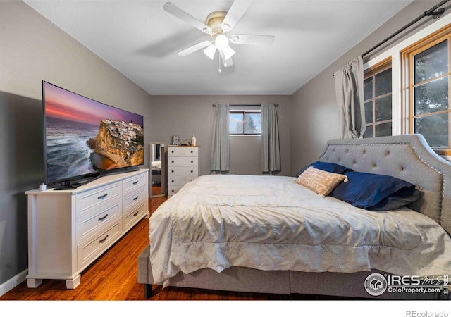 bedroom featuring hardwood / wood-style floors and ceiling fan