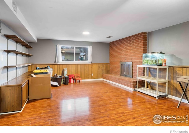 recreation room featuring a fireplace and light hardwood / wood-style flooring