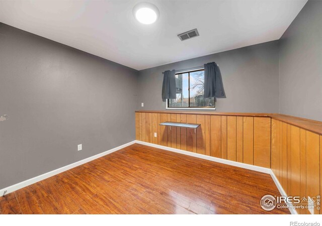 spare room with hardwood / wood-style floors