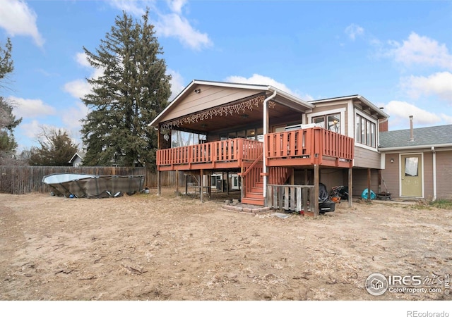 back of house with a wooden deck