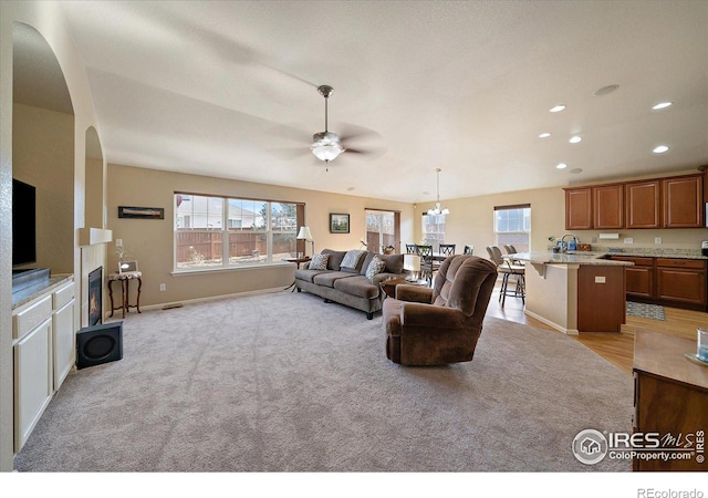 carpeted living room featuring ceiling fan