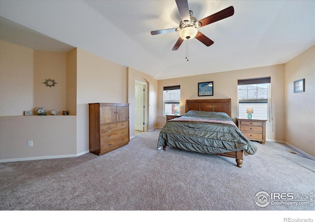 carpeted bedroom with vaulted ceiling and ceiling fan